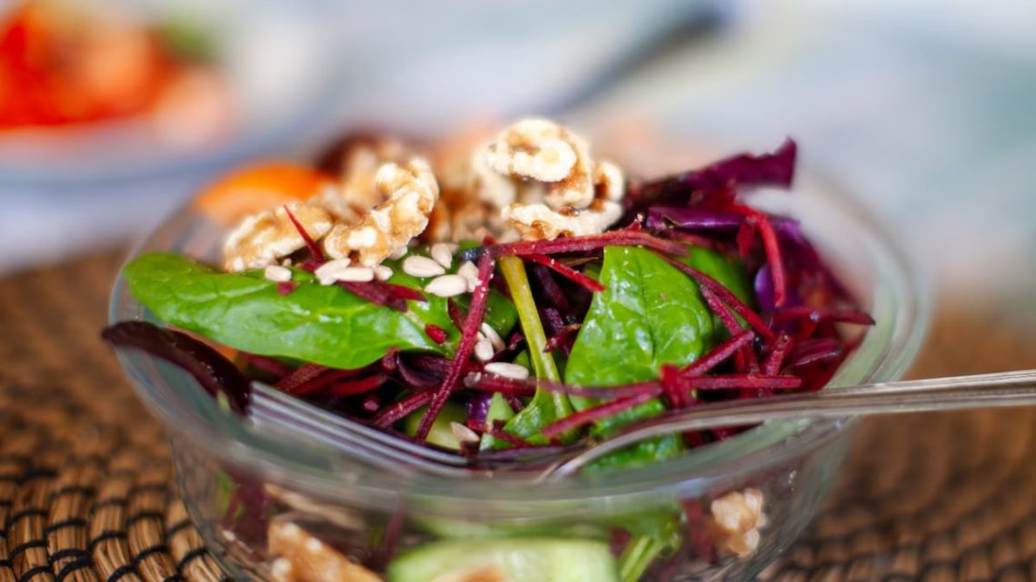 Vibrant beetroot and spinach salad with walnuts, perfect for a healthy meal.